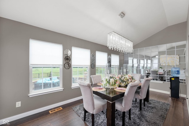 1143 Hampton Dr, Greenwood, IN 46143 - dining room with a chandelier, vaulted ceiling, and dark wood finished floors