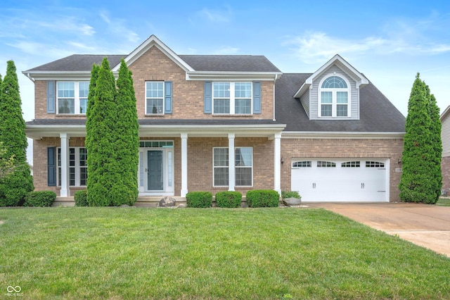 1143 Hampton Dr, Greenwood, IN 46143 - view of front of house featuring concrete driveway, brick siding, a front lawn, and a shingled roof