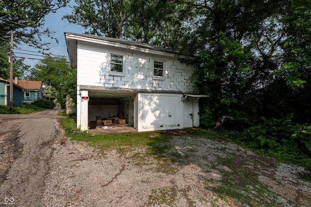 308 S Madison St, Bloomington, IN 47403 - back of property featuring driveway, an outbuilding, and an attached garage
