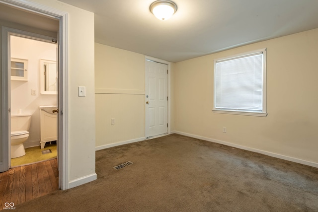 308 S Madison St, Bloomington, IN 47403 - unfurnished bedroom with carpet, baseboards, and connected bathroom