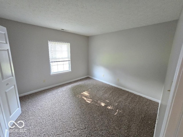 5825 Sapelo Dr, Indianapolis, IN 46237 - spare room featuring carpet flooring, baseboards, and a textured ceiling
