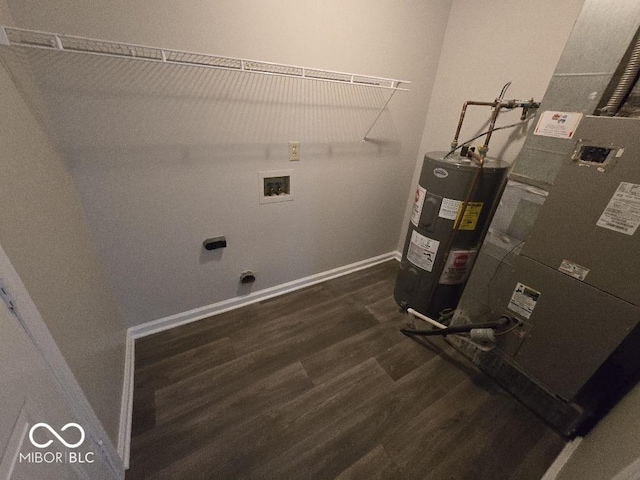 5825 Sapelo Dr, Indianapolis, IN 46237 - laundry area featuring water heater, electric dryer hookup, dark wood finished floors, washer hookup, and baseboards