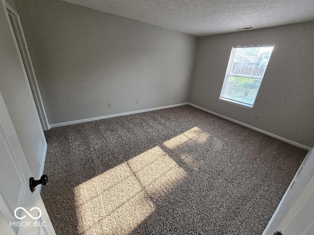 5825 Sapelo Dr, Indianapolis, IN 46237 - spare room featuring carpet floors, a textured ceiling, and baseboards