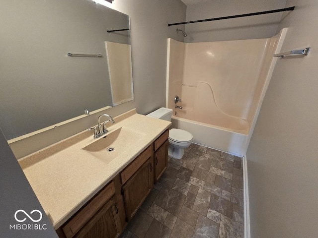5825 Sapelo Dr, Indianapolis, IN 46237 - full bathroom featuring vanity, washtub / shower combination, toilet, and stone finish flooring