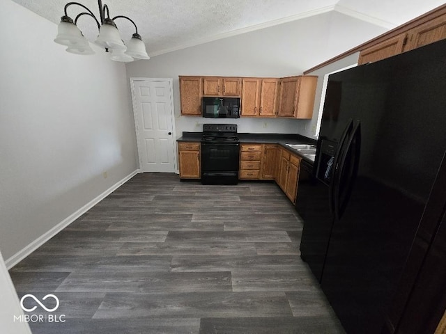5825 Sapelo Dr, Indianapolis, IN 46237 - kitchen with black appliances, dark countertops, a chandelier, brown cabinets, and lofted ceiling