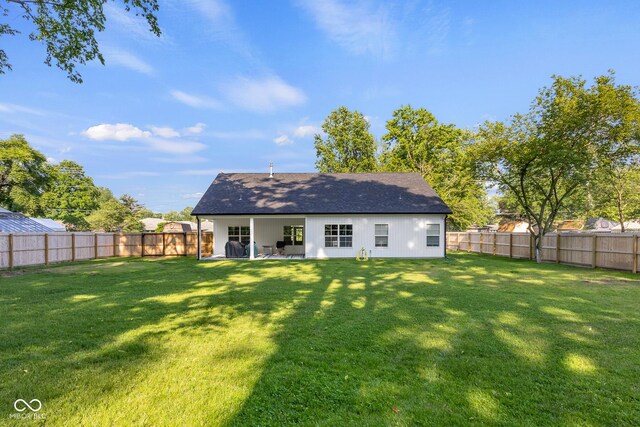 3365 Riverside Dr, Columbus, IN 47203 - back of house featuring a shingled roof and a patio