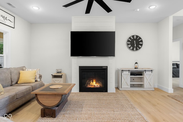 3365 Riverside Dr, Columbus, IN 47203 - living area with light wood-type flooring, ceiling fan, a glass covered fireplace, baseboards, and recessed lighting