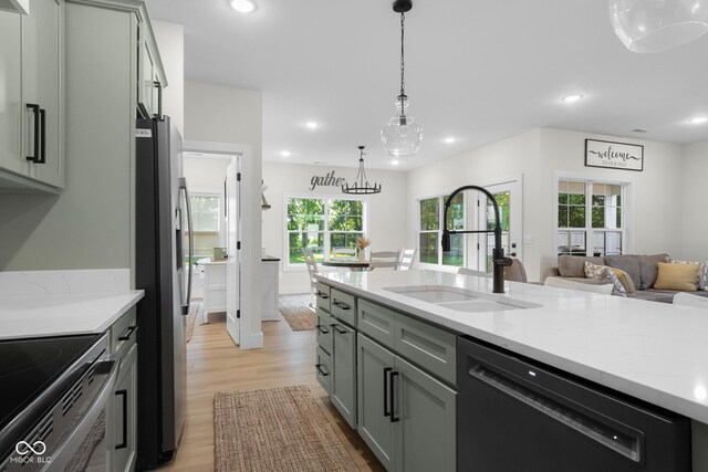 3365 Riverside Dr, Columbus, IN 47203 - kitchen with black dishwasher, a sink, stainless steel fridge with ice dispenser, light wood-style flooring, and hanging light fixtures