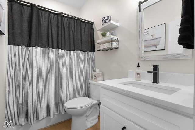 3365 Riverside Dr, Columbus, IN 47203 - full bath featuring vanity, toilet, a shower with curtain, and wood finished floors