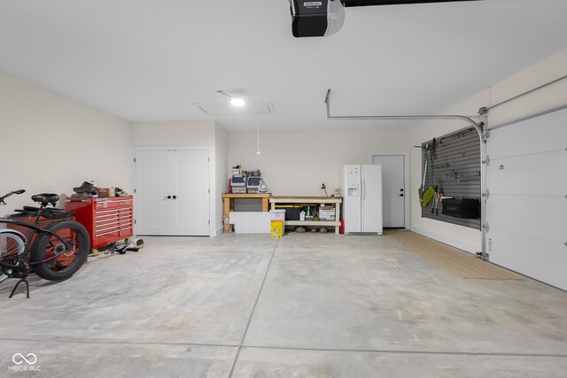 3365 Riverside Dr, Columbus, IN 47203 - garage with white fridge with ice dispenser and a garage door opener