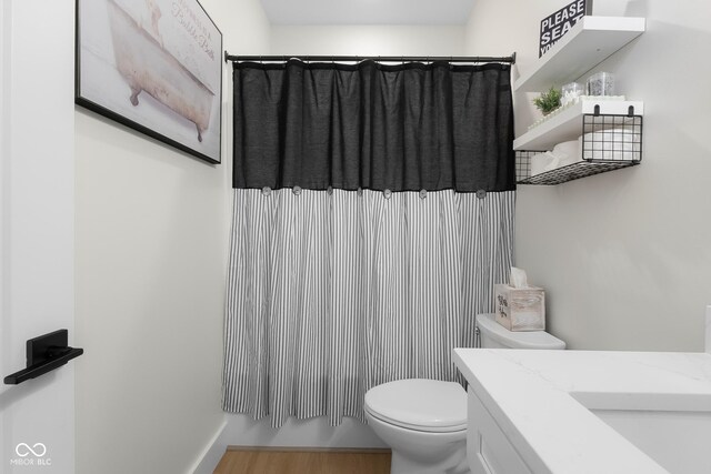 3365 Riverside Dr, Columbus, IN 47203 - full bathroom featuring toilet, vanity, wood finished floors, and a shower with shower curtain