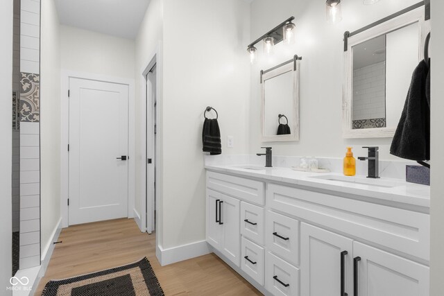 3365 Riverside Dr, Columbus, IN 47203 - full bath featuring double vanity, wood finished floors, and baseboards