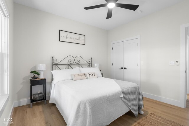 3365 Riverside Dr, Columbus, IN 47203 - bedroom with light wood-type flooring, a closet, baseboards, and a ceiling fan