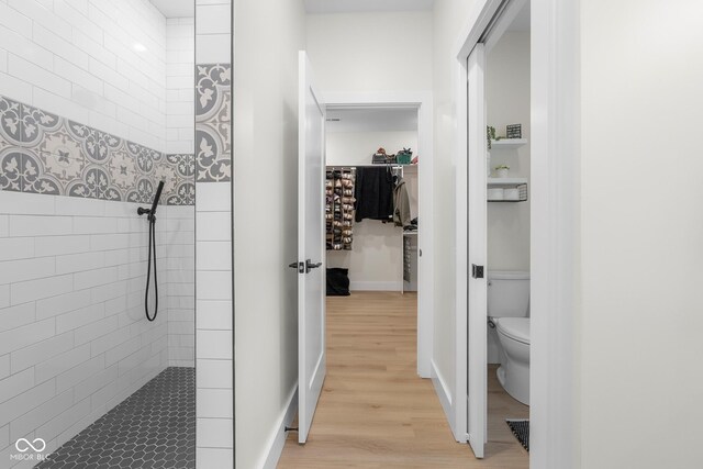 3365 Riverside Dr, Columbus, IN 47203 - full bath with toilet, tiled shower, and wood finished floors