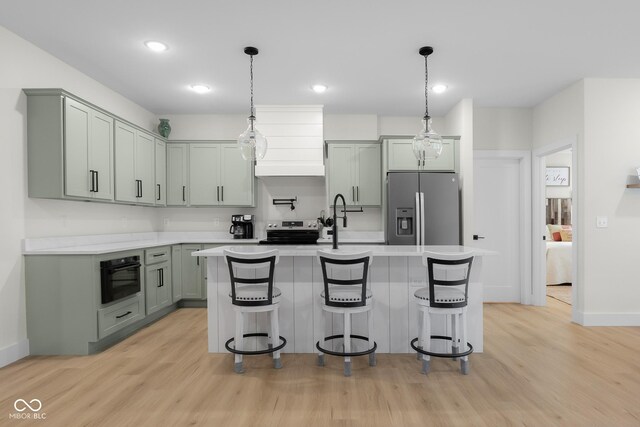 3365 Riverside Dr, Columbus, IN 47203 - kitchen with appliances with stainless steel finishes, light countertops, light wood-style floors, wall chimney exhaust hood, and recessed lighting