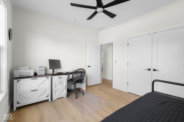 3365 Riverside Dr, Columbus, IN 47203 - bedroom with light wood-style floors, an office area, a ceiling fan, and a closet