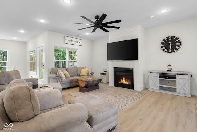 3365 Riverside Dr, Columbus, IN 47203 - living room featuring light wood finished floors, plenty of natural light, recessed lighting, a glass covered fireplace, and ceiling fan