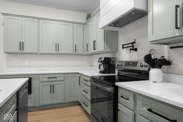 3365 Riverside Dr, Columbus, IN 47203 - kitchen with range with electric stovetop, custom range hood, light stone counters, light wood-type flooring, and stainless steel dishwasher