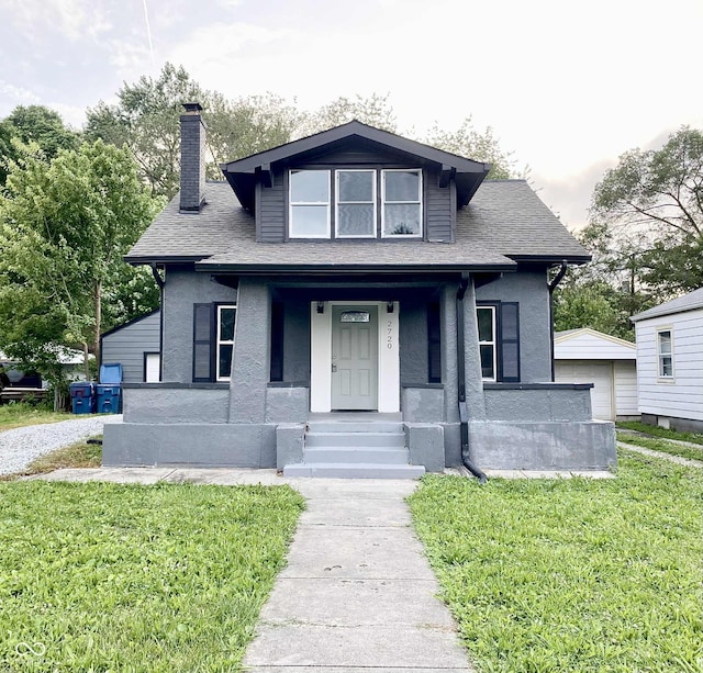 2720 S Taft Ave, Indianapolis, IN 46241 - bungalow with a chimney, a porch, a front yard, and stucco siding