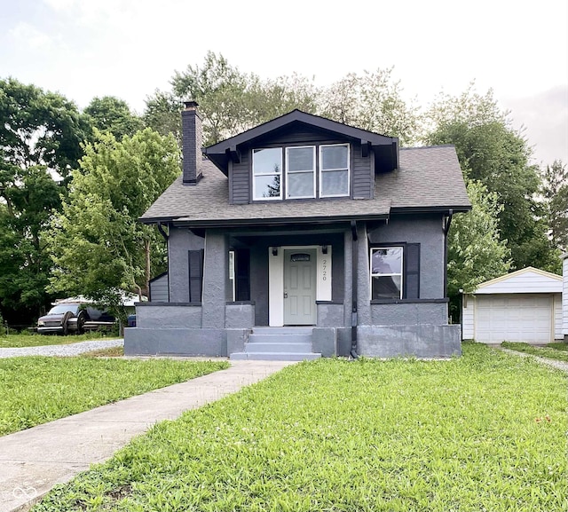 2720 S Taft Ave, Indianapolis, IN 46241 - bungalow featuring a front lawn, a chimney, a porch, and a garage