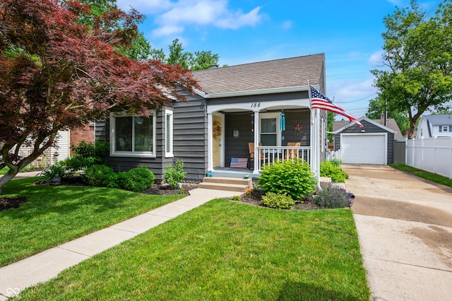188 Maple Ln, Franklin, IN 46131 - view of front facade featuring concrete driveway, covered porch, an outbuilding, a detached garage, and a shingled roof