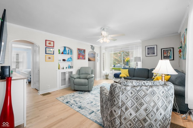188 Maple Ln, Franklin, IN 46131 - living area featuring arched walkways, crown molding, light wood-style flooring, a ceiling fan, and baseboards