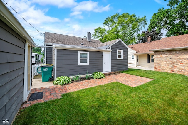 188 Maple Ln, Franklin, IN 46131 - back of property with a lawn, a patio area, and a chimney