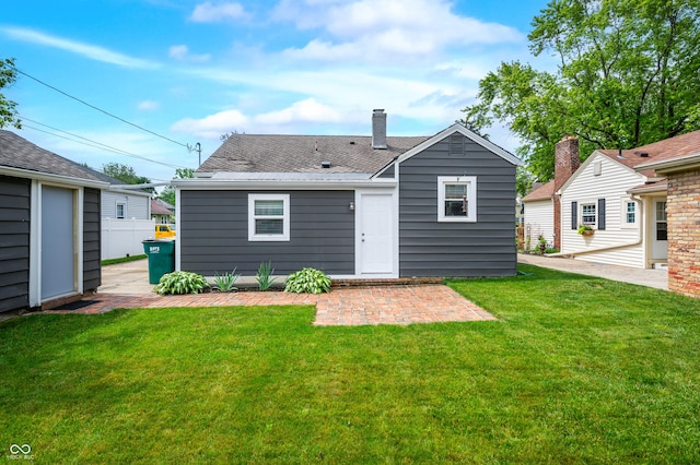 188 Maple Ln, Franklin, IN 46131 - rear view of property featuring a lawn, roof with shingles, a chimney, and a patio