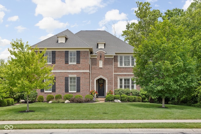 4529 Panthera Leo Dr, Carmel, IN 46074 - colonial-style house with a front lawn, brick siding, and a shingled roof