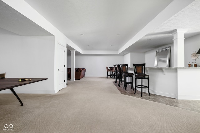 4529 Panthera Leo Dr, Carmel, IN 46074 - carpeted dining space with decorative columns, tile patterned floors, and a tray ceiling