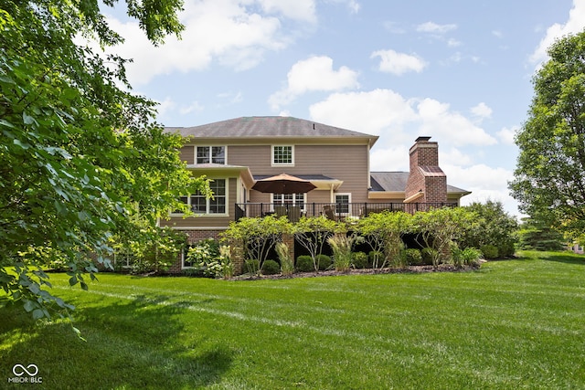 4529 Panthera Leo Dr, Carmel, IN 46074 - back of house with a yard, a chimney, and a wooden deck