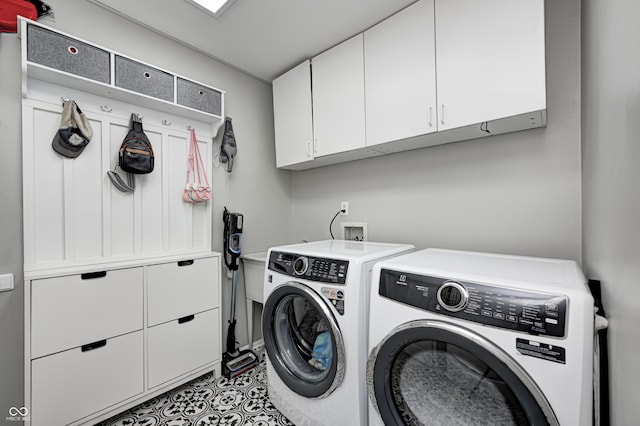 10717 Windermere Blvd, Fishers, IN 46037 - washroom featuring separate washer and dryer, cabinet space, and tile patterned flooring