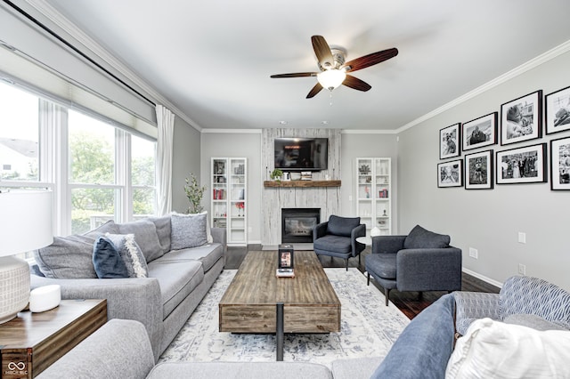 10717 Windermere Blvd, Fishers, IN 46037 - living room with ceiling fan, a large fireplace, crown molding, and wood finished floors