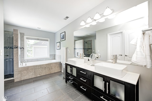 10717 Windermere Blvd, Fishers, IN 46037 - bathroom featuring a shower stall, double vanity, a garden tub, and tile patterned floors