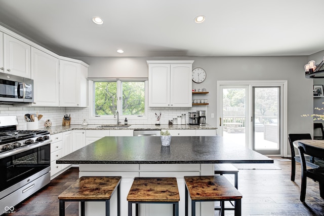 10717 Windermere Blvd, Fishers, IN 46037 - kitchen with appliances with stainless steel finishes, plenty of natural light, a kitchen breakfast bar, backsplash, and recessed lighting