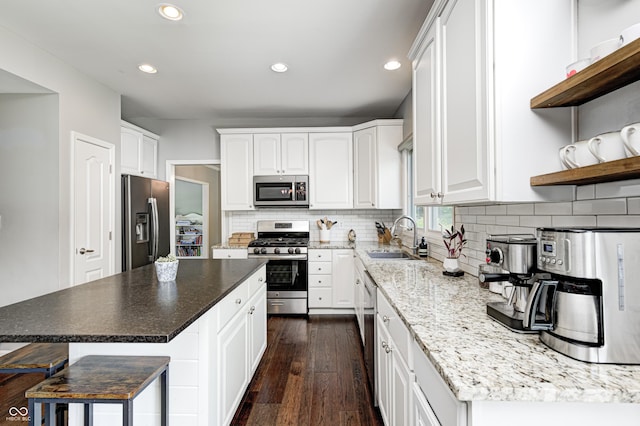 10717 Windermere Blvd, Fishers, IN 46037 - kitchen featuring appliances with stainless steel finishes, recessed lighting, dark wood-type flooring, white cabinetry, and decorative backsplash