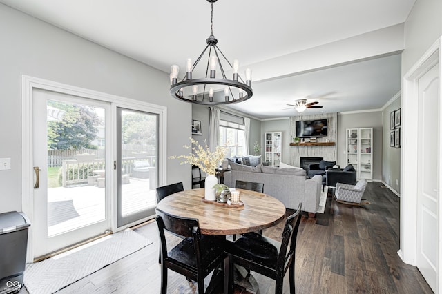 10717 Windermere Blvd, Fishers, IN 46037 - dining room featuring dark wood finished floors, a large fireplace, ceiling fan, a chandelier, and ornamental molding