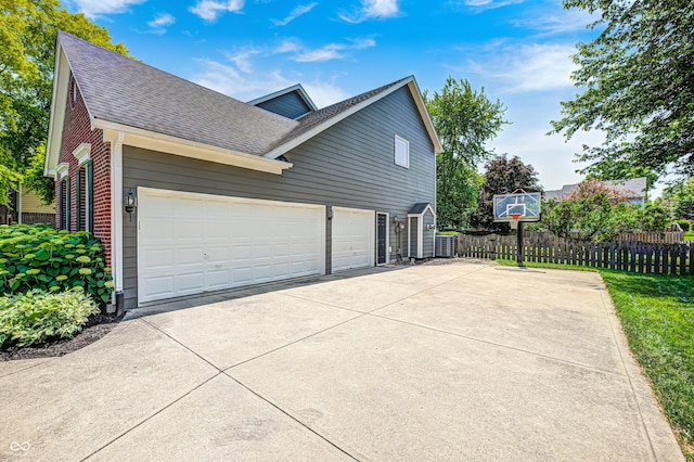 10717 Windermere Blvd, Fishers, IN 46037 - view of property exterior featuring roof with shingles, driveway, an attached garage, and brick siding