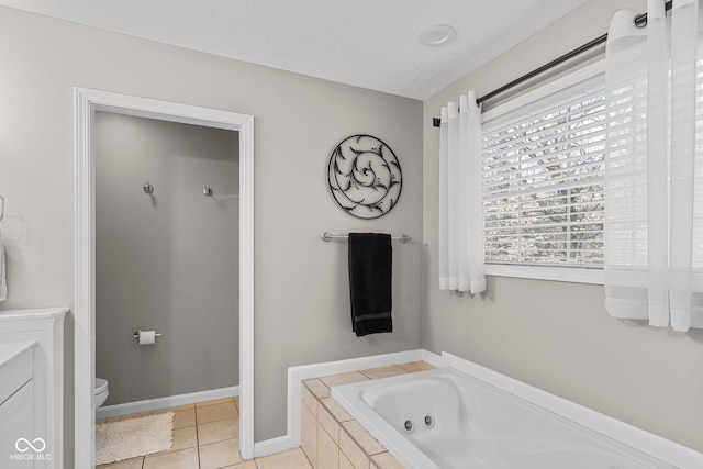 128 Walts Rd, Georgetown, IN 47122 - bathroom with a tub with jets, toilet, tile patterned floors, vanity, and a textured ceiling