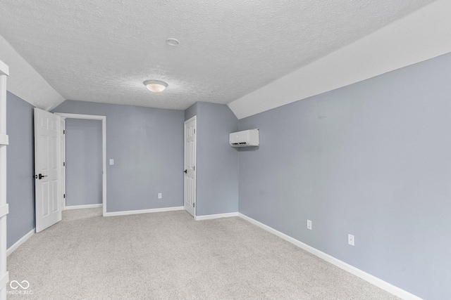 128 Walts Rd, Georgetown, IN 47122 - carpeted empty room featuring lofted ceiling, a wall unit AC, a textured ceiling, and baseboards