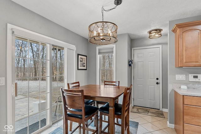 128 Walts Rd, Georgetown, IN 47122 - dining room with light tile patterned floors, a chandelier, and baseboards