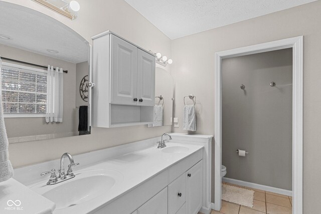 128 Walts Rd, Georgetown, IN 47122 - full bathroom featuring double vanity, toilet, tile patterned flooring, baseboards, and a textured ceiling
