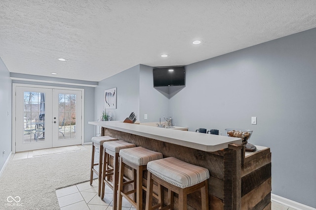 128 Walts Rd, Georgetown, IN 47122 - indoor wet bar with a textured ceiling, light carpet, recessed lighting, baseboards, and french doors