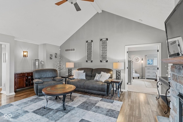128 Walts Rd, Georgetown, IN 47122 - living room featuring a fireplace, wood finished floors, a ceiling fan, high vaulted ceiling, and beam ceiling