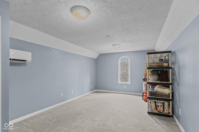 128 Walts Rd, Georgetown, IN 47122 - recreation room with lofted ceiling, a textured ceiling, carpet floors, baseboards, and a wall mounted air conditioner