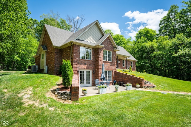 128 Walts Rd, Georgetown, IN 47122 - view of side of home featuring french doors, a patio area, a lawn, brick siding, and central air condition unit
