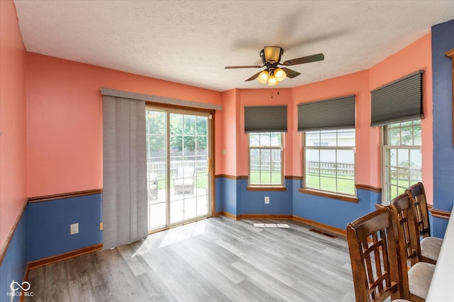 1159 Oak Leaf Rd, Franklin, IN 46131 - unfurnished dining area with wood finished floors, ceiling fan, and a textured ceiling