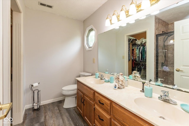 1159 Oak Leaf Rd, Franklin, IN 46131 - bathroom featuring a stall shower, wood finished floors, double vanity, and a spacious closet