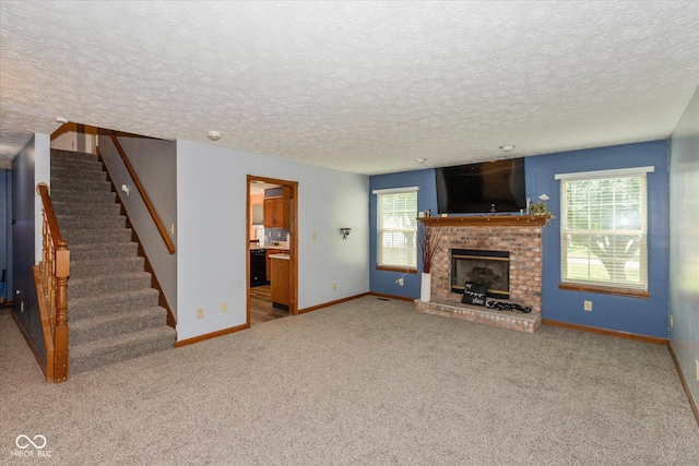 1159 Oak Leaf Rd, Franklin, IN 46131 - unfurnished living room featuring stairway, a textured ceiling, carpet, and a brick fireplace