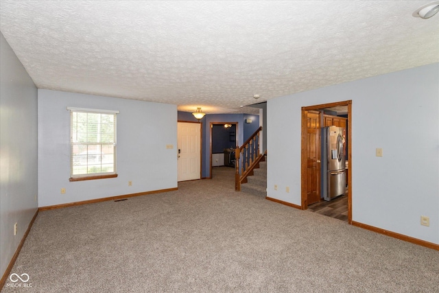 1159 Oak Leaf Rd, Franklin, IN 46131 - empty room featuring carpet, stairs, and a textured ceiling